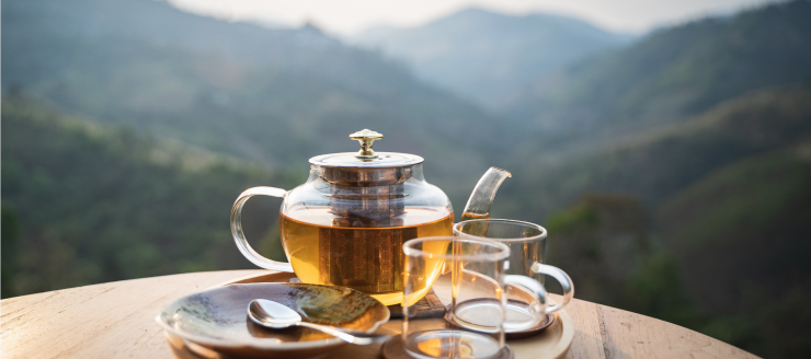 two glasses of tea with teapot