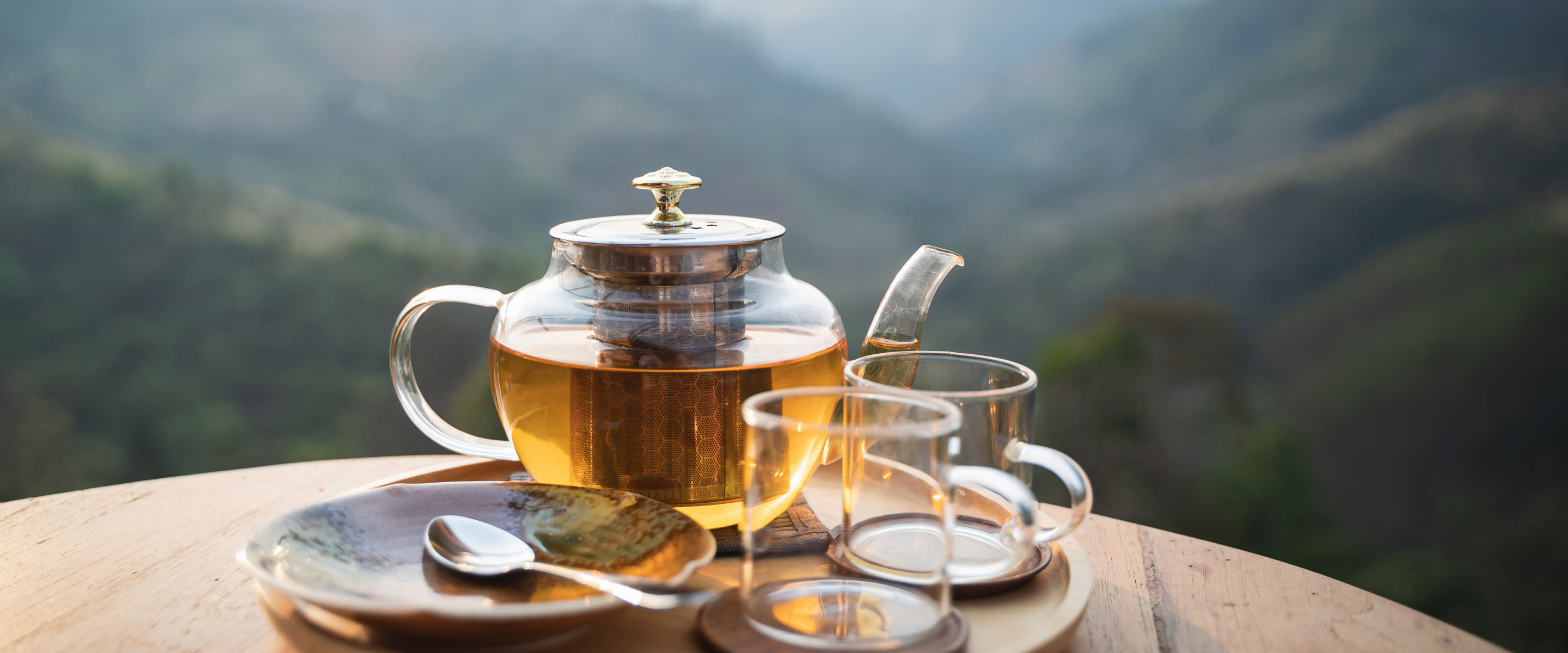 two glasses of tea with teapot