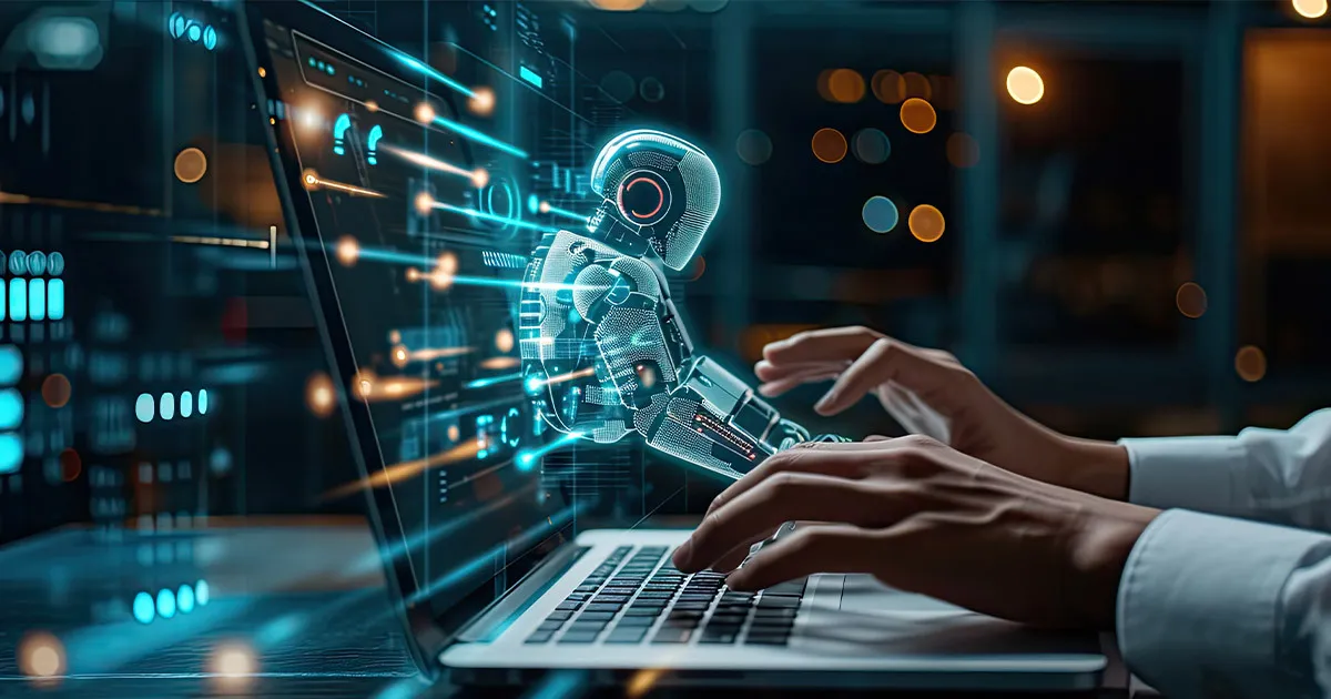 A person is typing on a laptop with a robotic arm on the screen.