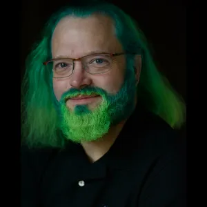 A man with green hair and a green beard.