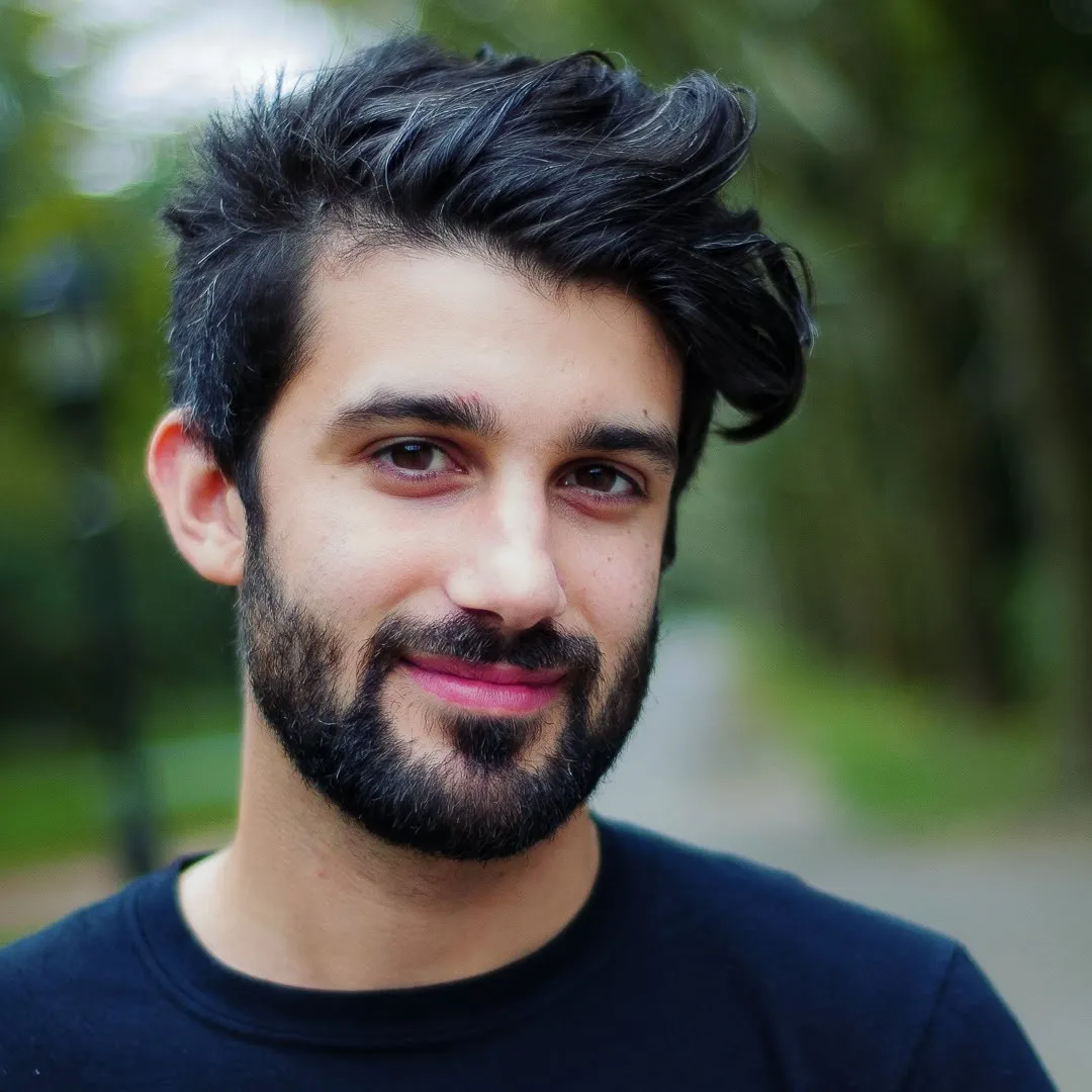 A man with a black shirt and a beard.