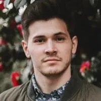 A man with a beard and a blue shirt.