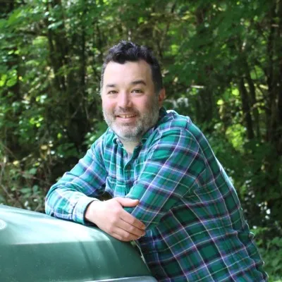 A man with a beard and a green shirt.