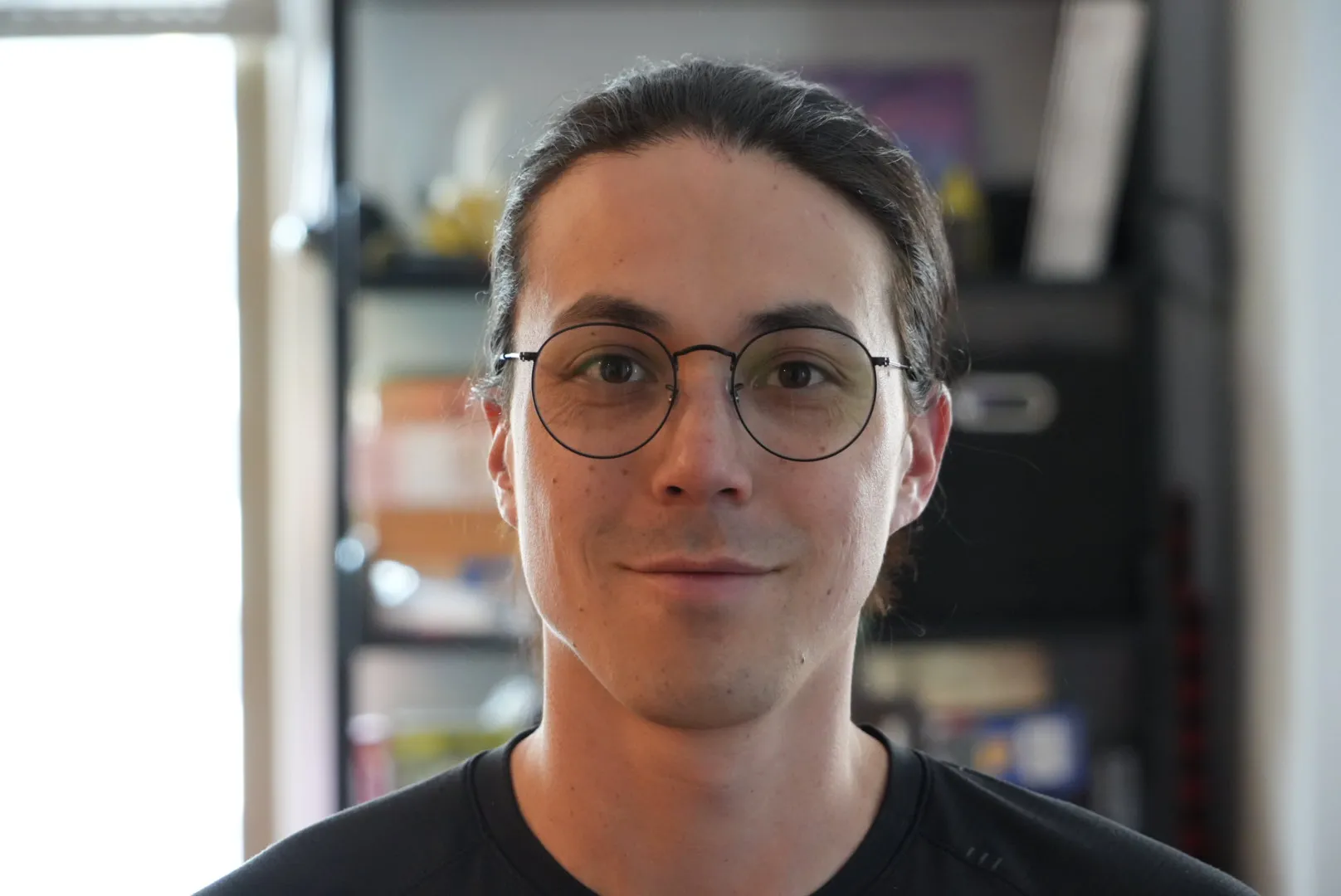 A man wearing glasses and a black shirt.