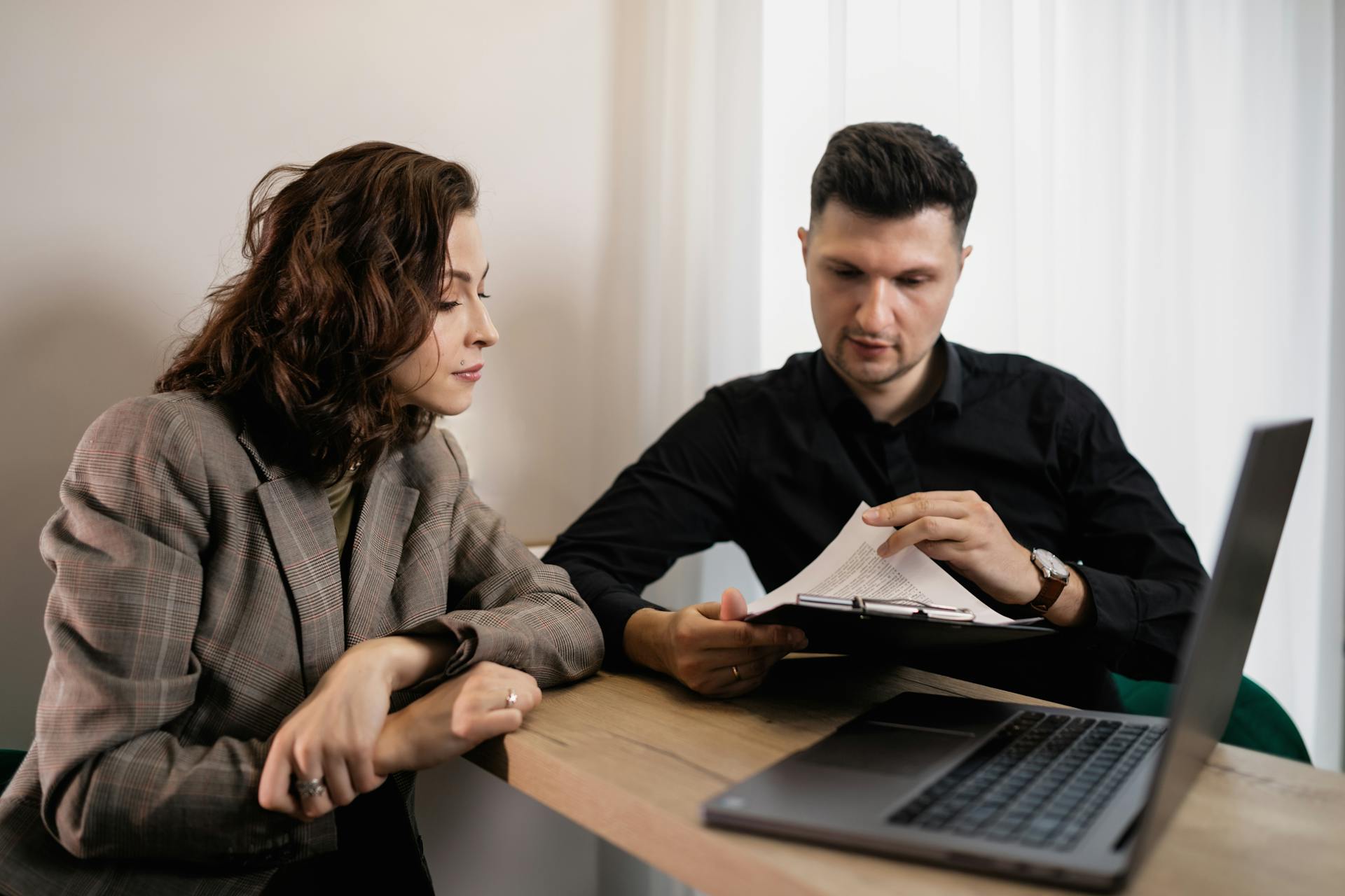 A Couple Reading a Document on a Clipboard