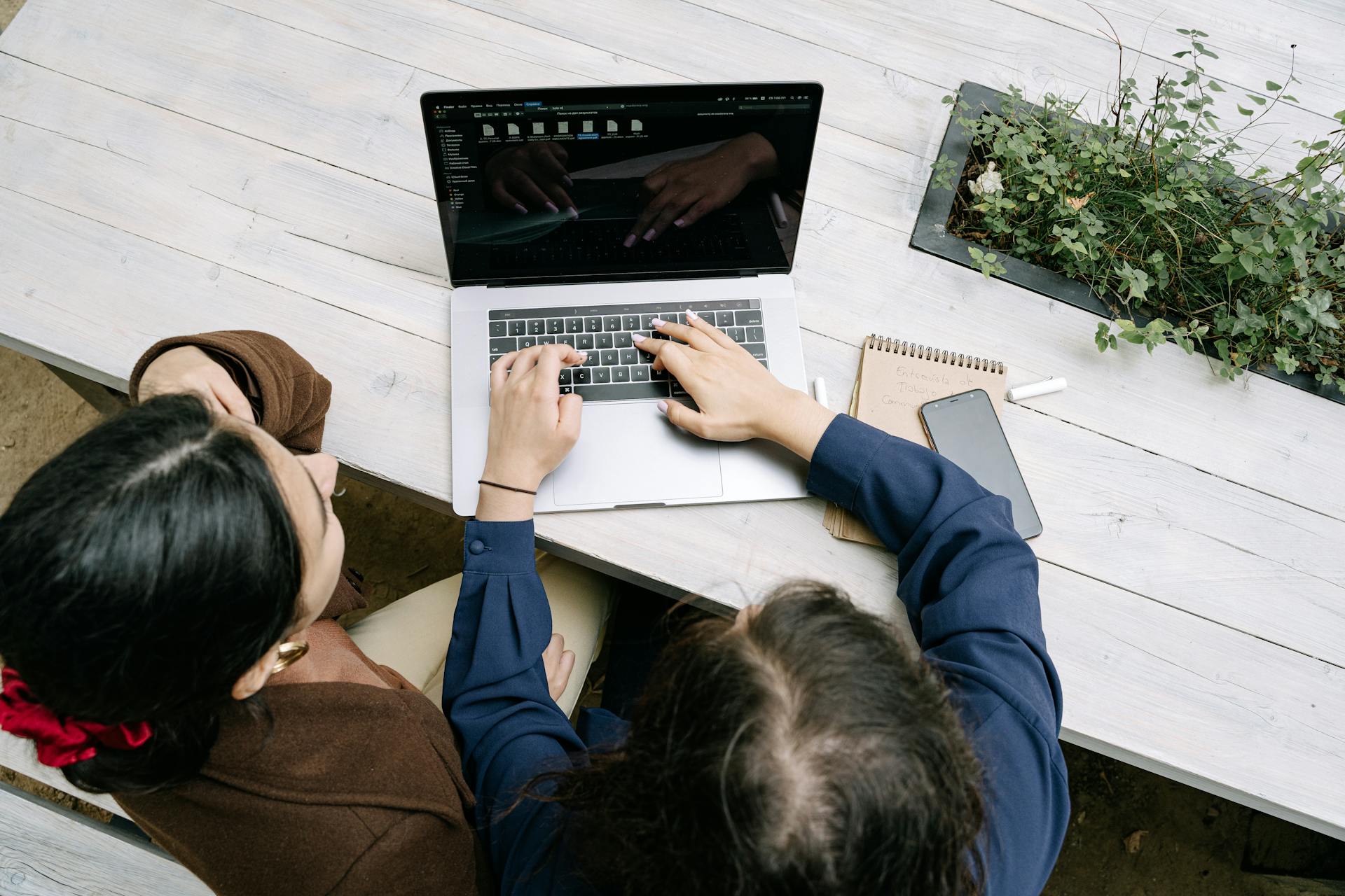 Overhead Shot of Colleagues using a laptop