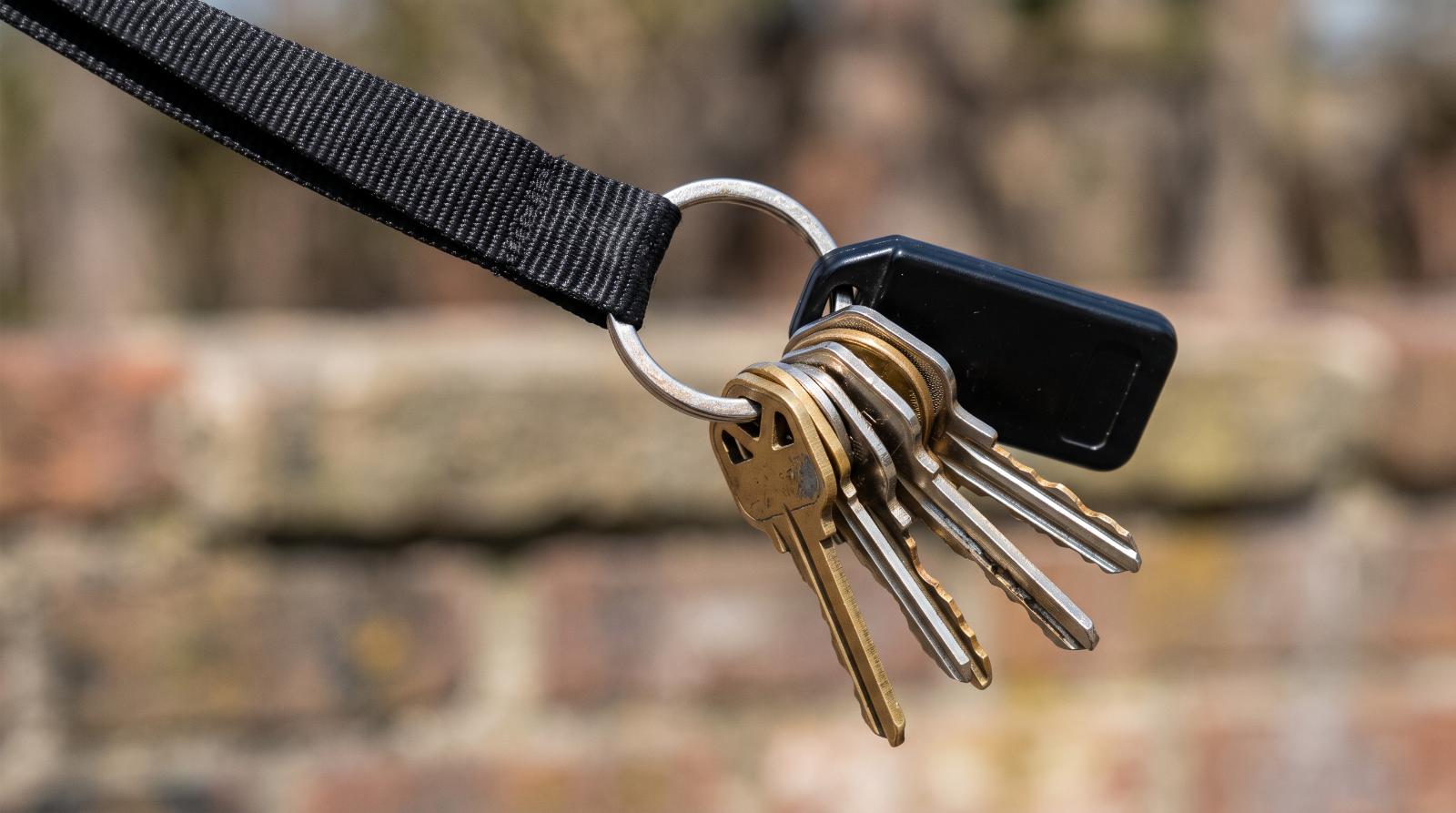 close-up photograph of a ring of keys on a lanyard captured mid-swing