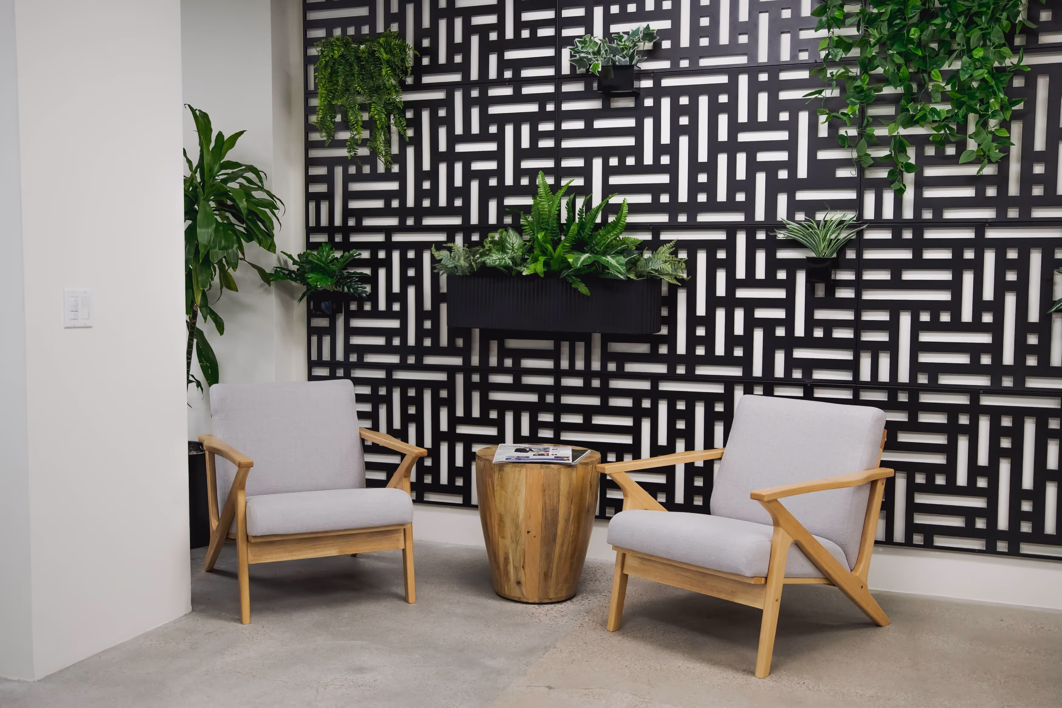 Private phone room with 2 chairs and plants on the wall