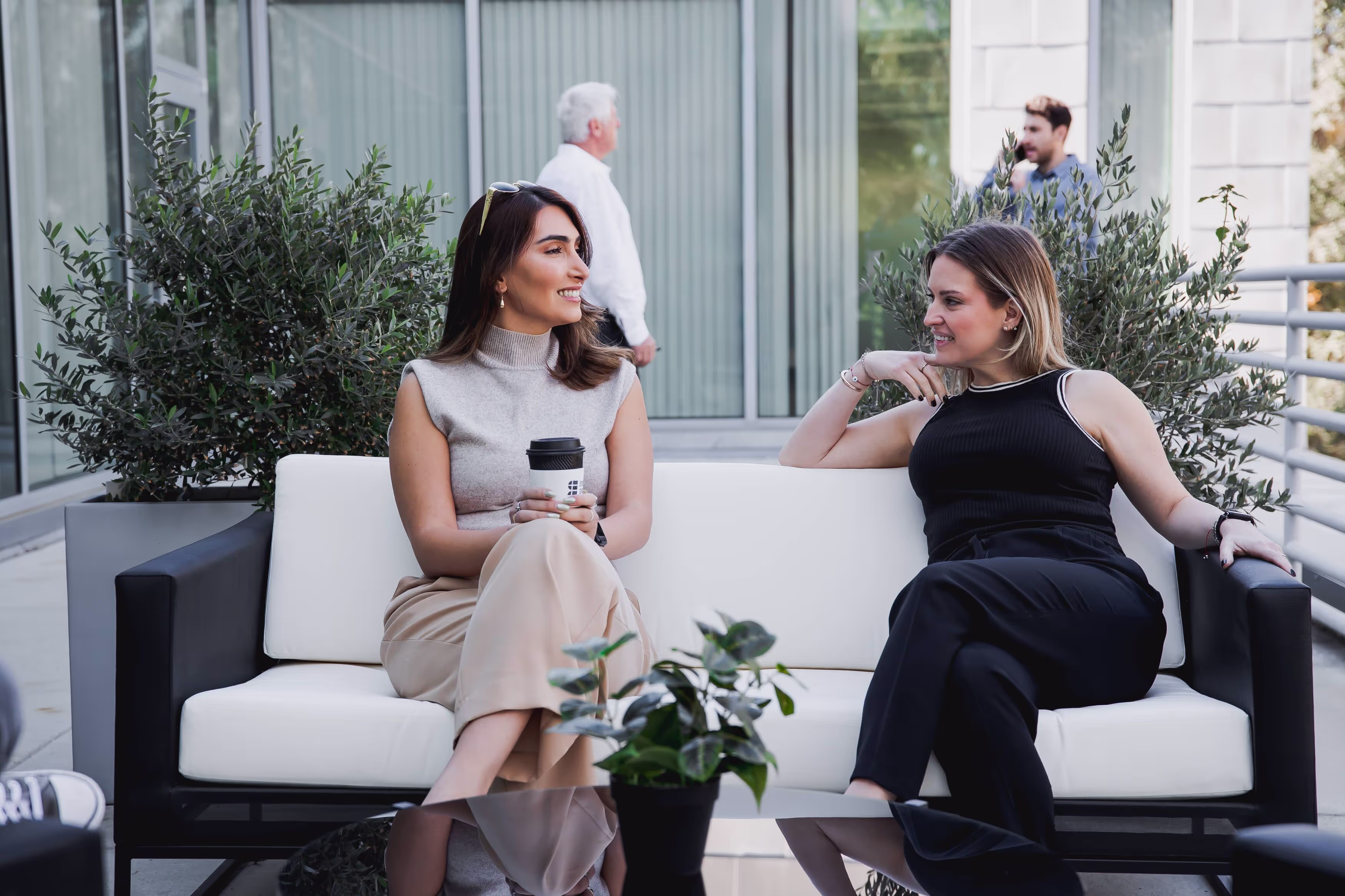 Coworkers chatting outside on the office patio