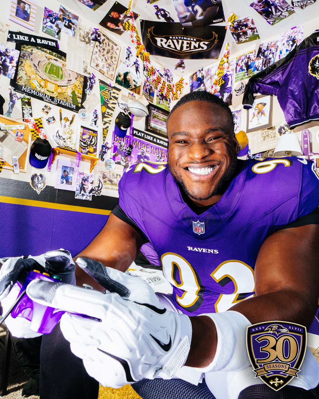Beeks smiles at the camera in his Baltimore Ravens jersey on set for the 30th anniversary media day shoot