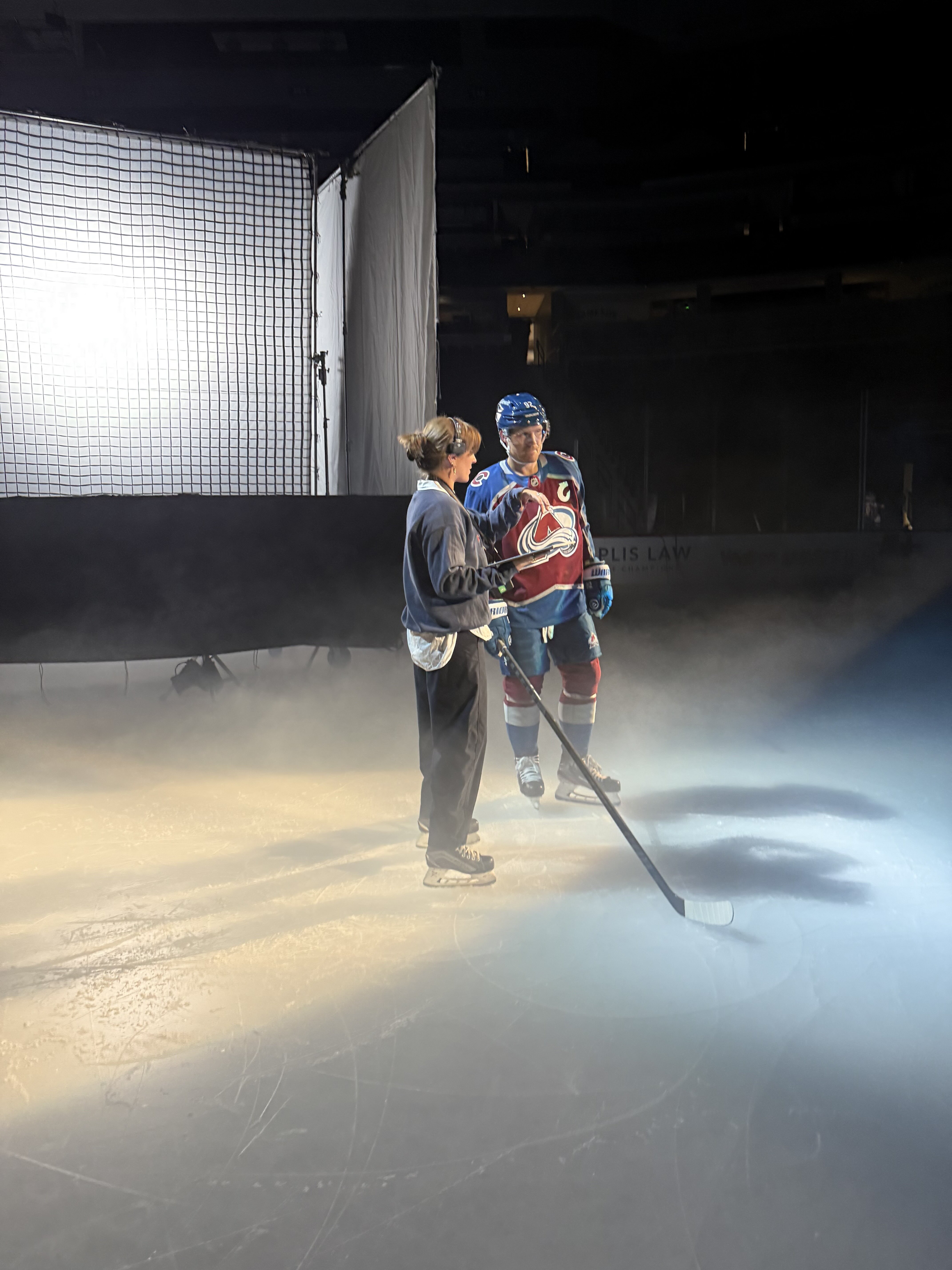 Fresh Tape Media Producer Avalon chats with Colorado Avalanche Captain Gabe Landeskog in front of a large grid light