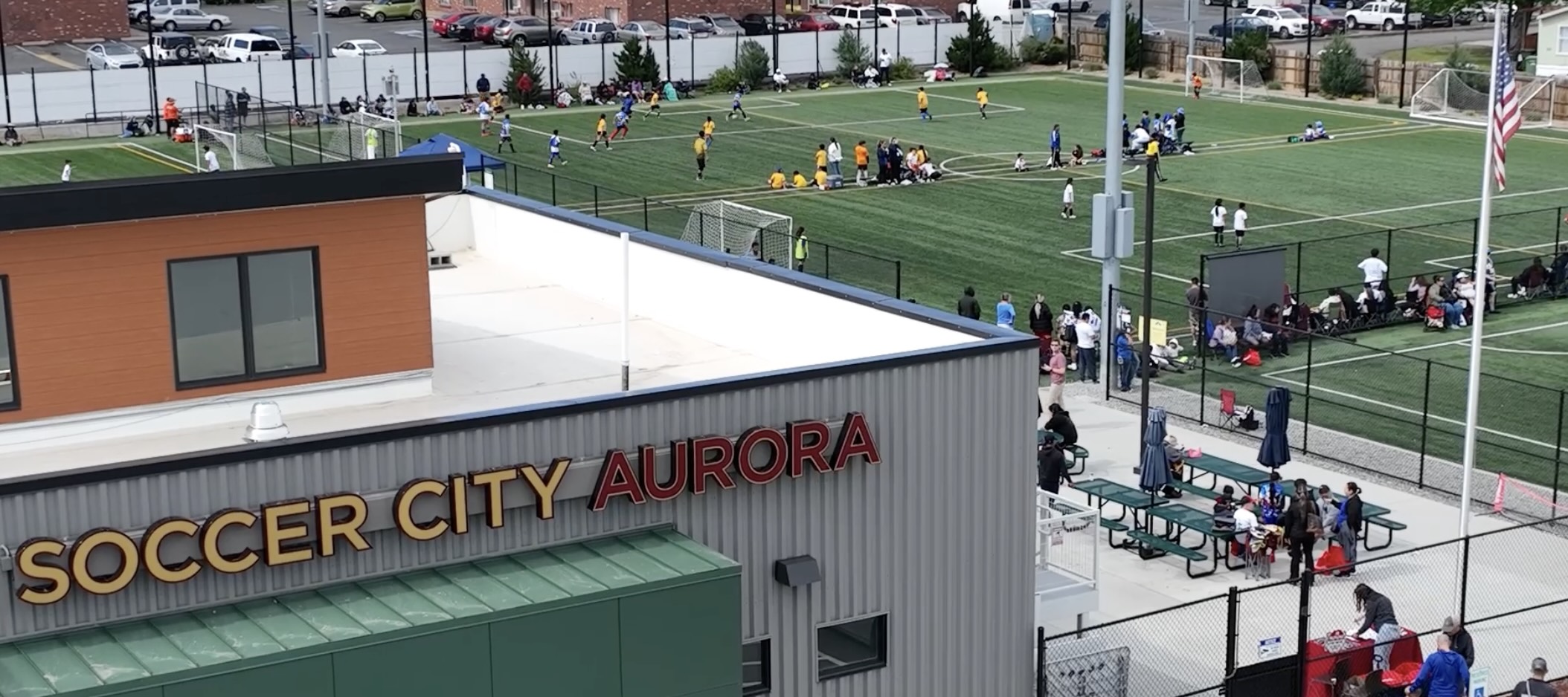 Exterior shot of Soccer City in Aurora Colorado with surrounding fields that are active with players