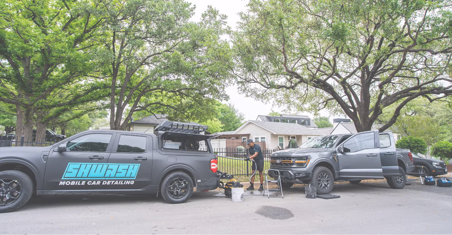 SHWASH mobile car detailing truck servicing a vehicle in Austin TX