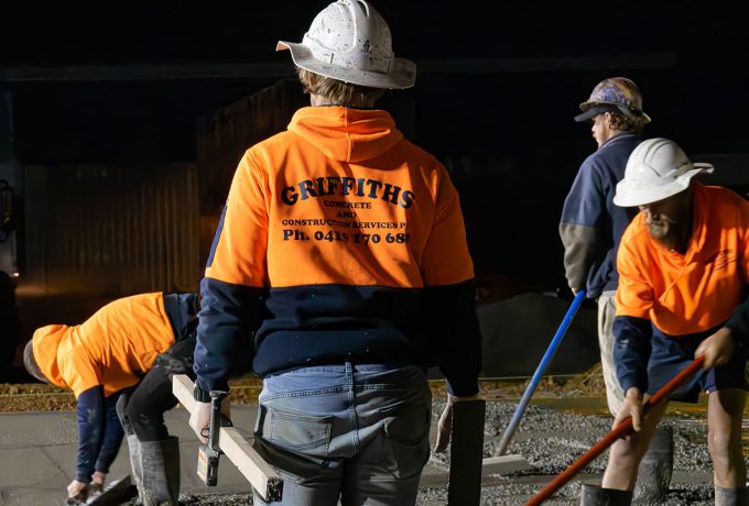 Construction workers actively pouring and finishing concrete on-site — Concreting Services Toowoomba, QLD