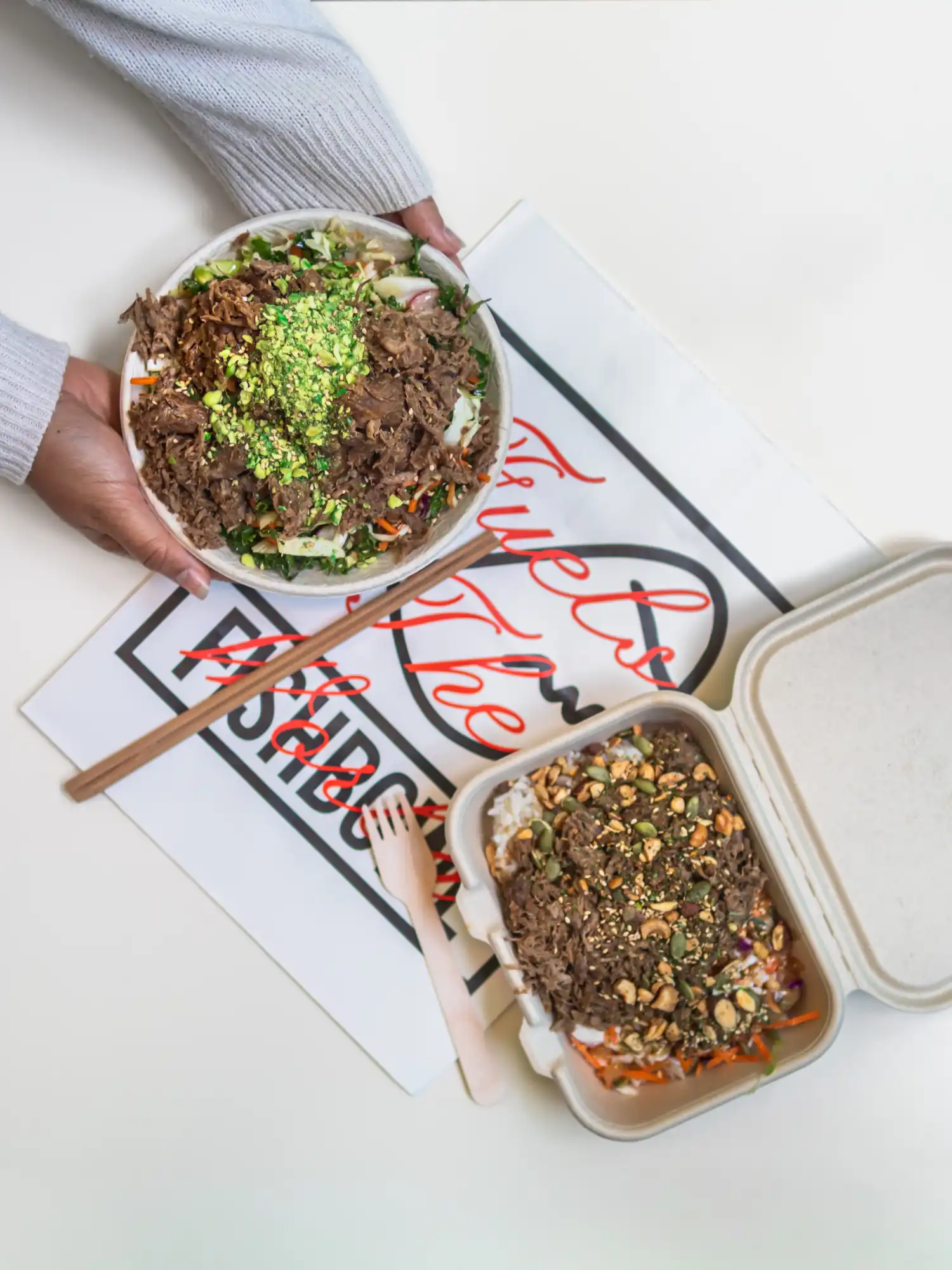 Flatlay food photography of Fishbowl vegan takeaway salad bowls and packaging