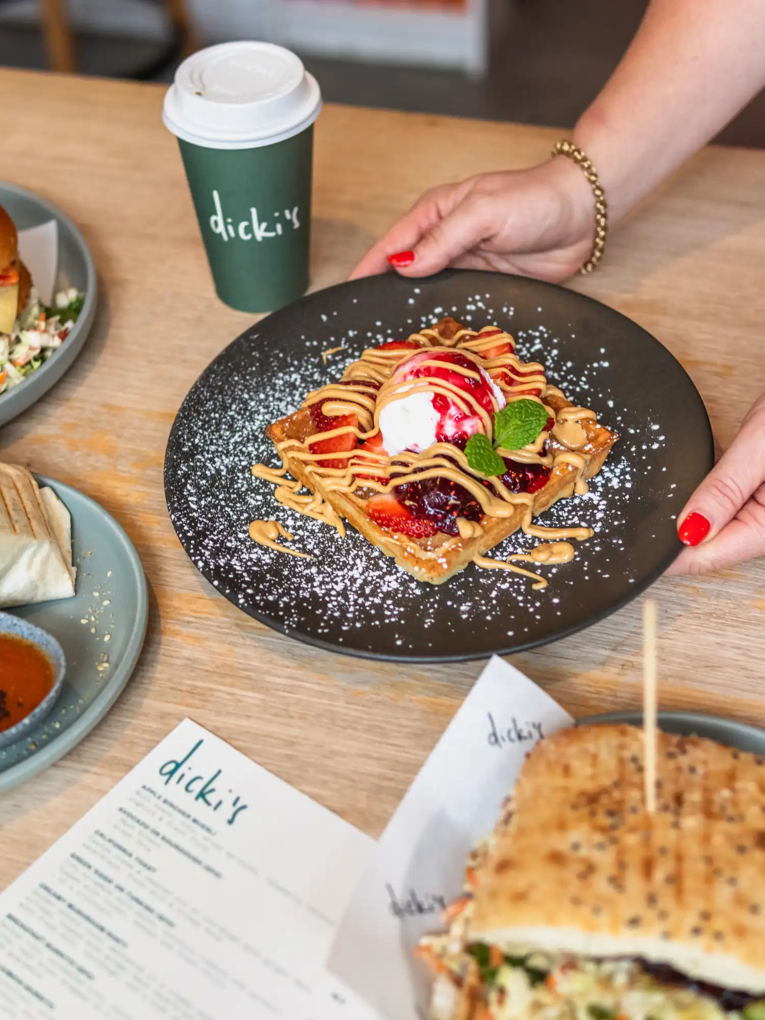 Custom restaurant website design for Vega Cafe Brisbane displaying vegan Thai menu on laptop