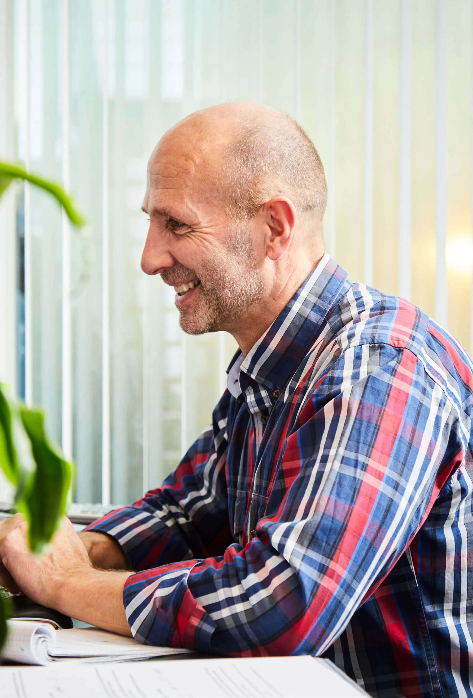 A man smiling and sitting at a table