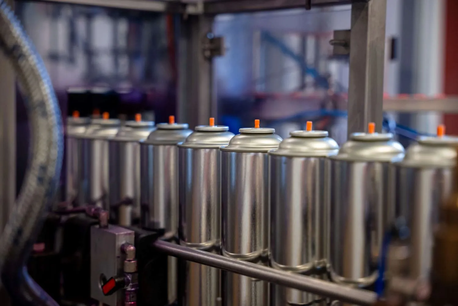 A lot of filled aerosol cans on an assembling line
