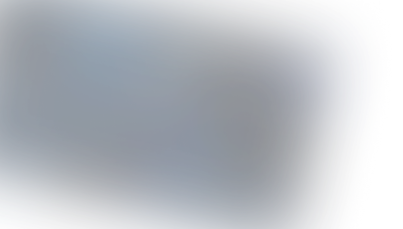 Modern workspace with an open laptop displaying a bar chart, a notepad with pen, a cup of coffee, and reading glasses on a wooden table.