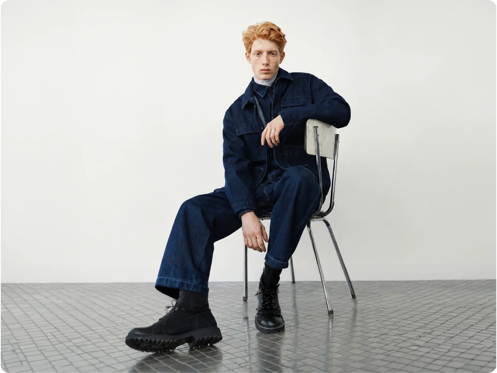 Seated AI generated model in navy workwear