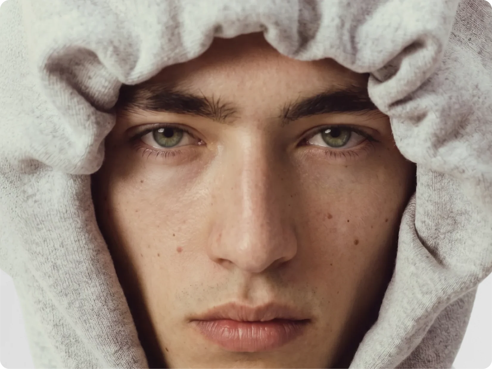 AI generated model in a grey hood, close portrait