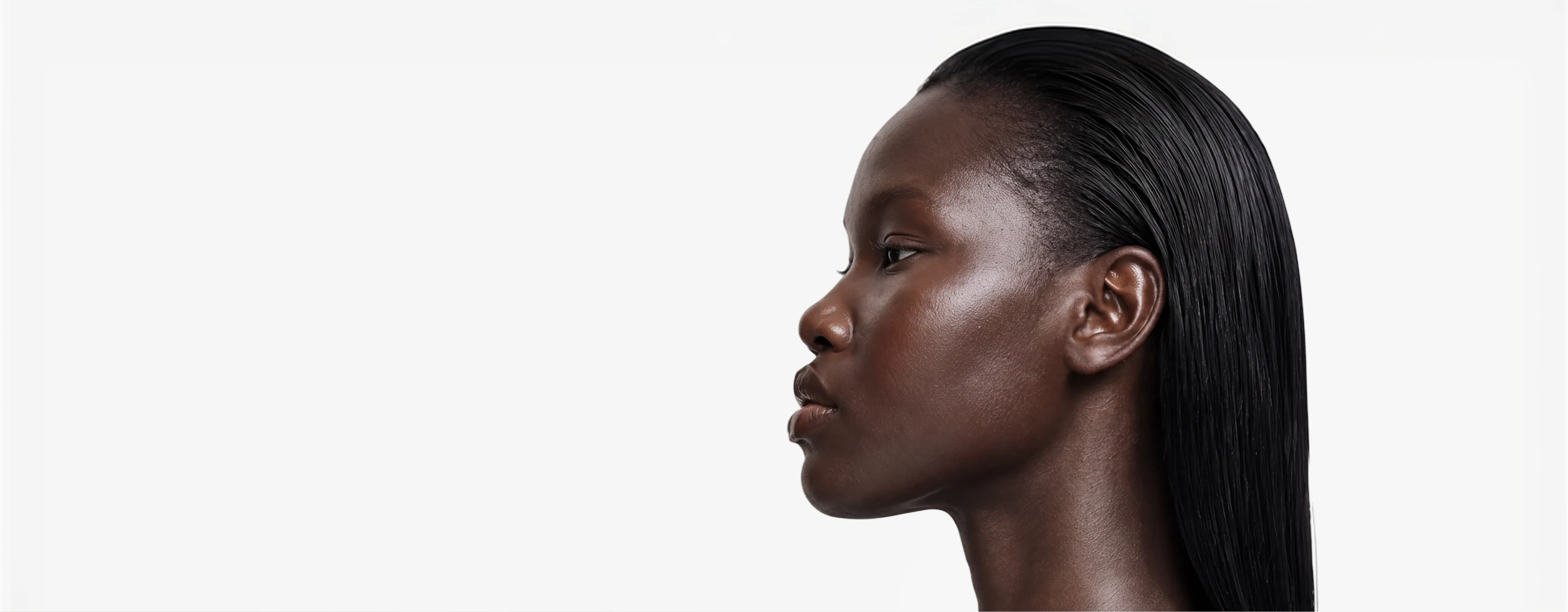 AI generated model with slicked back hair in profile against a pale studio background