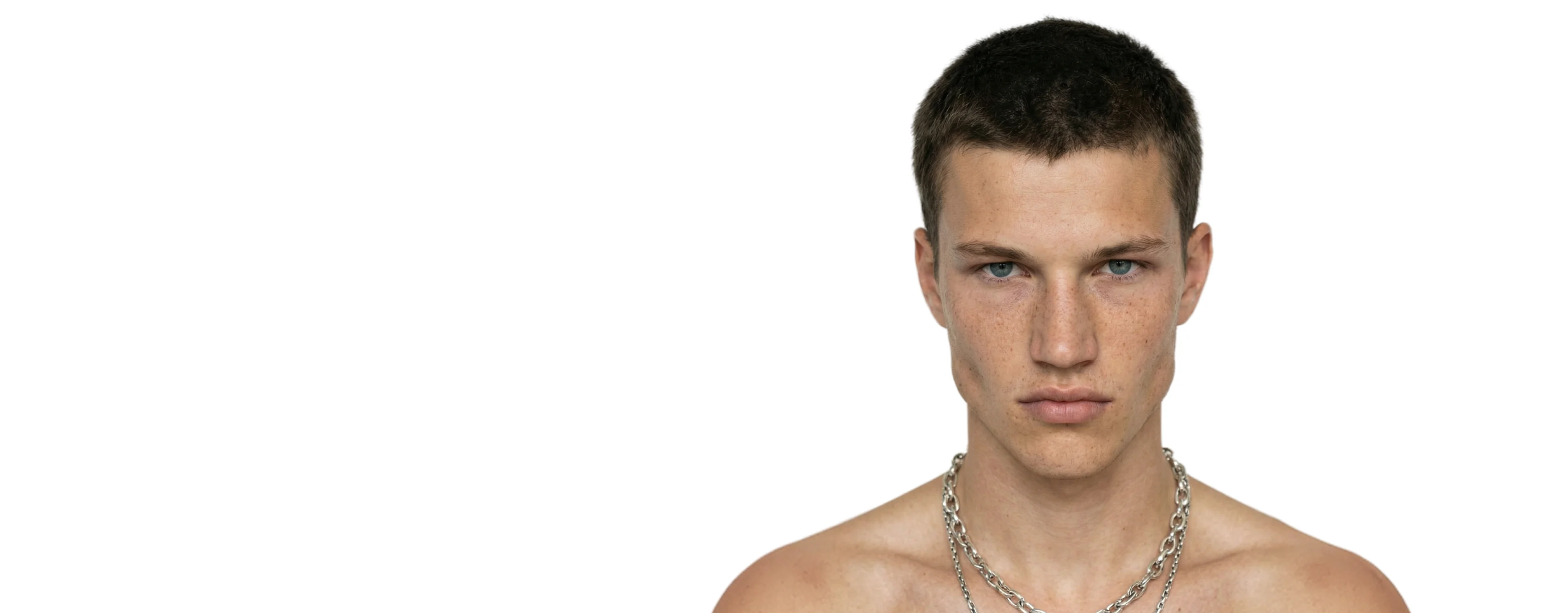 AI generated male model wearing a silver chain necklace against a pale studio background