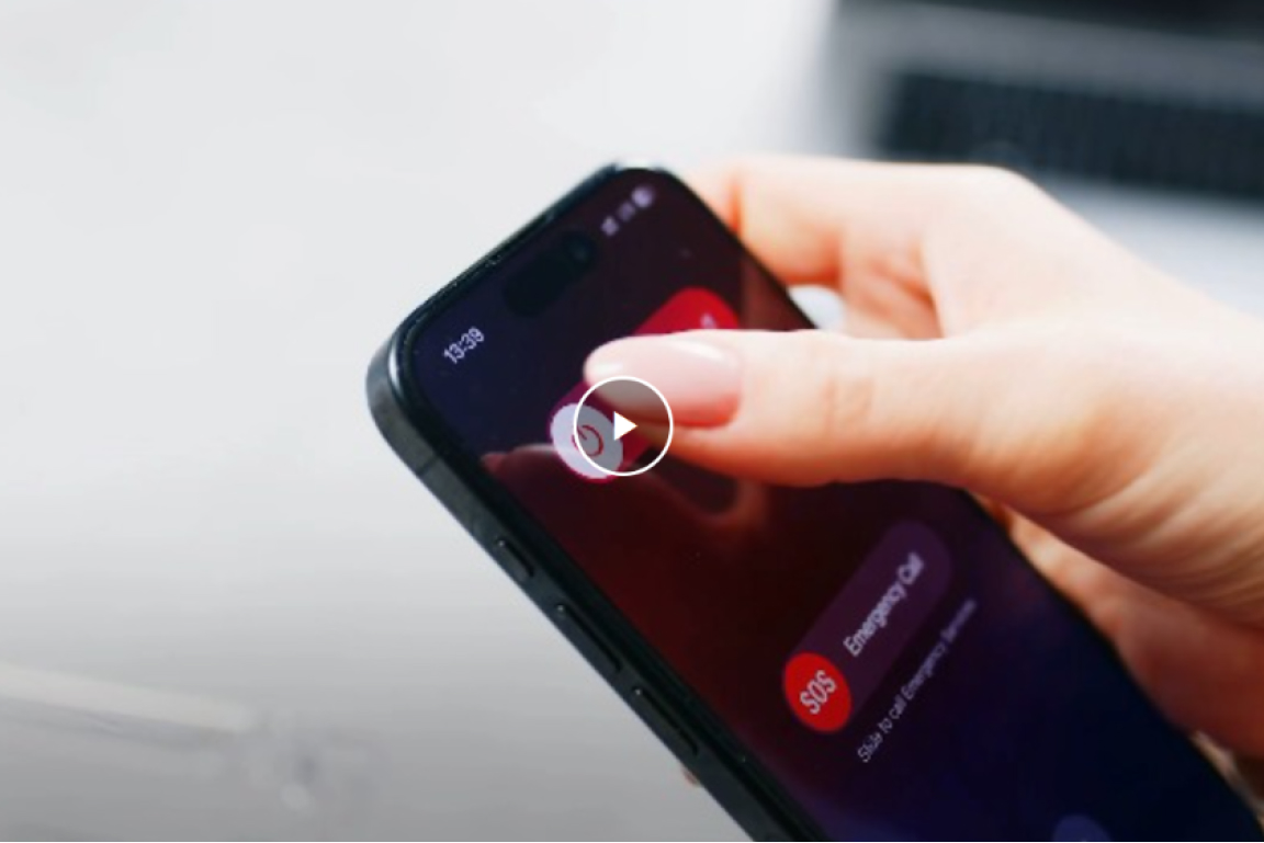 Hand holding smartphone with finger near screen showing SOS emergency call option.