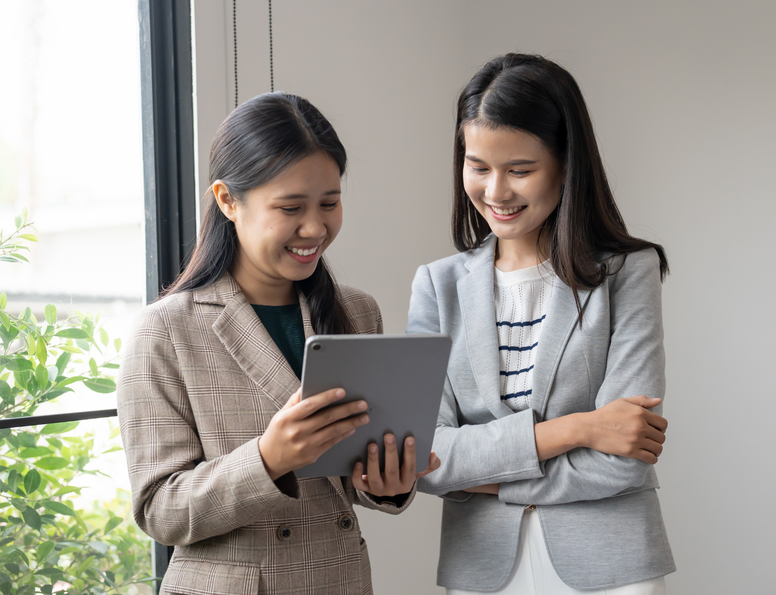 Two women founders sharing an iPad