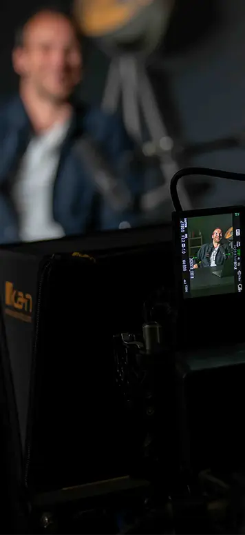 Camera monitor displaying a brand advertisement scene during a Graphrs video shoot
