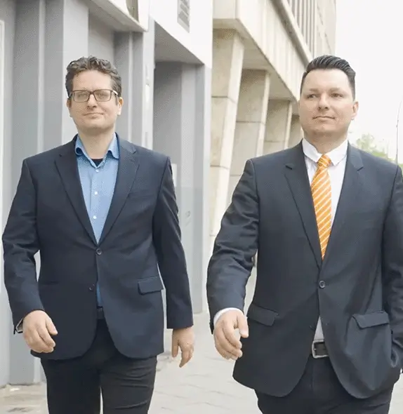 Two company executives walking outside an office building in Berlin for an employer branding video shoot