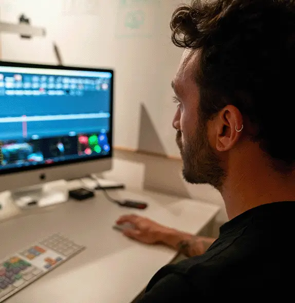 Video editor working on real-time edits using a laptop in Munich