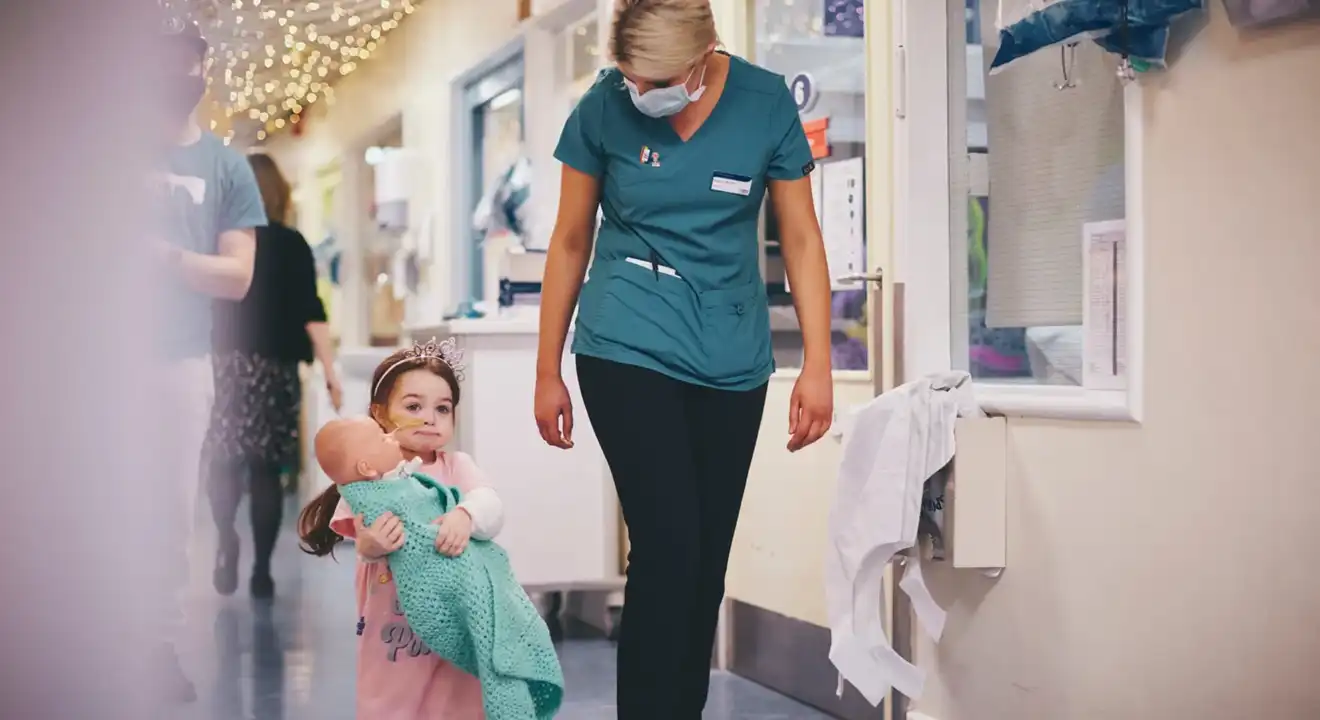 Nurse walking with young child through the hospital coridors