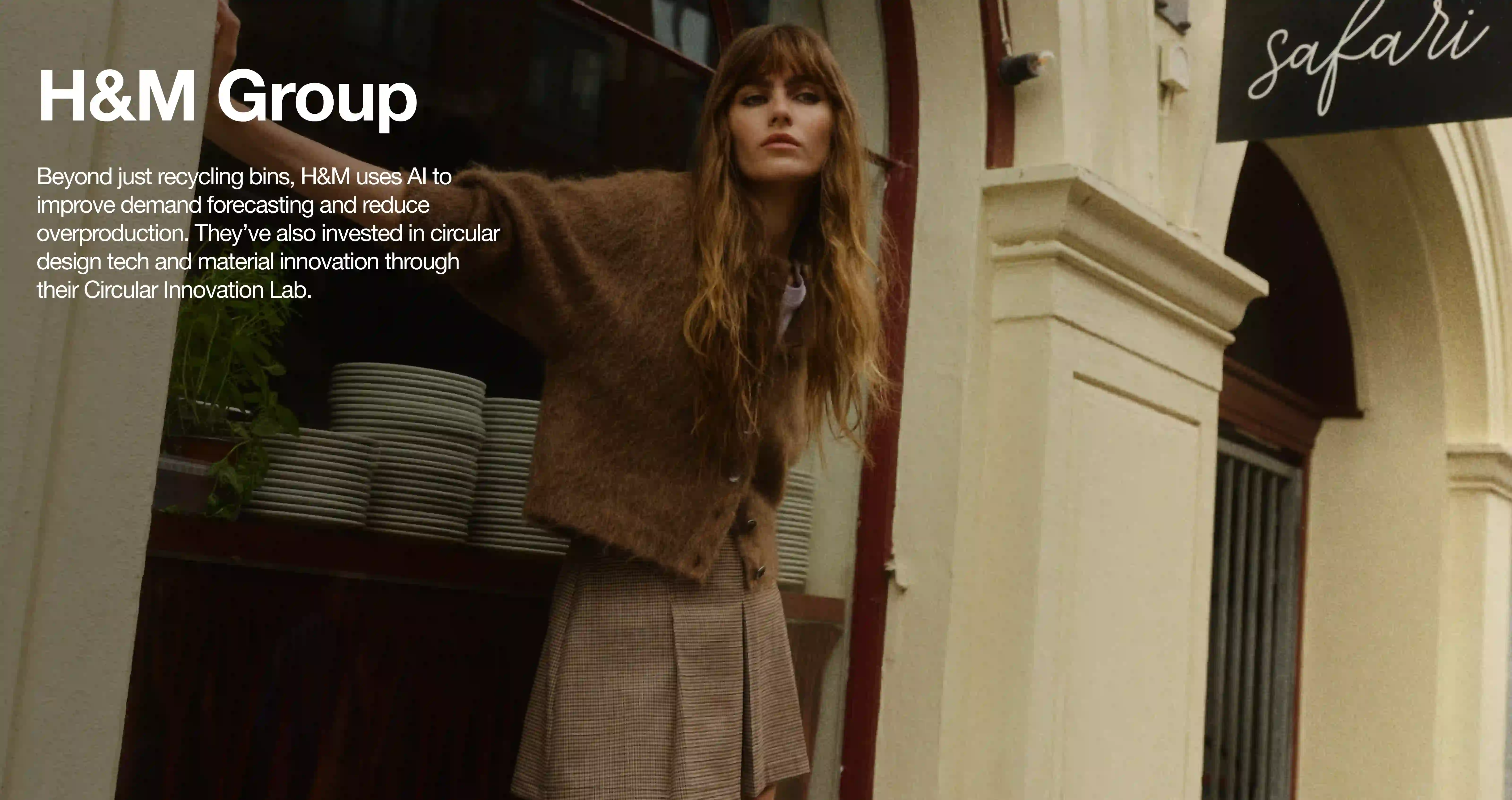 Campaign photo from H&M Group featuring a model in front of a storefront in Europe.
