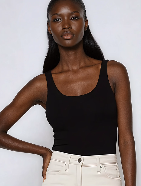 Headshot of a black female AI fashion model wearing a black tank top and white jeans. 