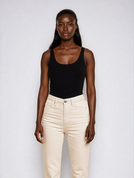 Black female AI fashion model wearing a black tank top and white jeans and looking back over her shoulder. 