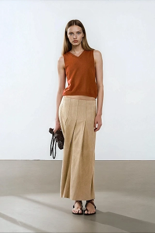 Anouk, a Botika AI fashion model wearing a rust colored sleeveless shirt with a flowing kachki ankle length skirt. 
