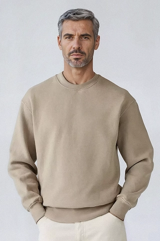 A Botika male AI fashion model, Liam, in a black and white photo wearing an oversized tshirt and ripped jeans. 