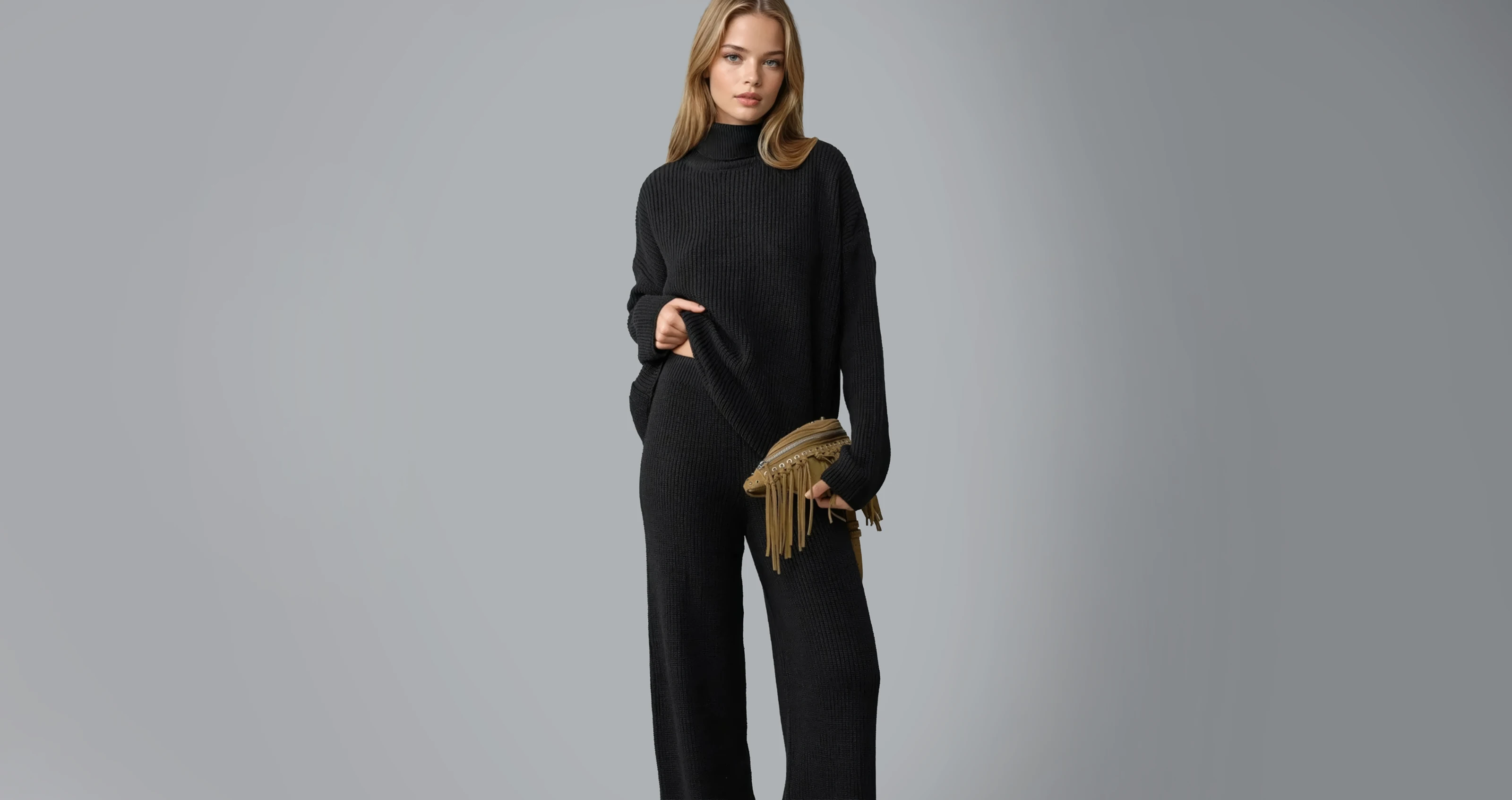 A blonde female Botika AI fashion model wearing a black knit turtleneck and matching pants.