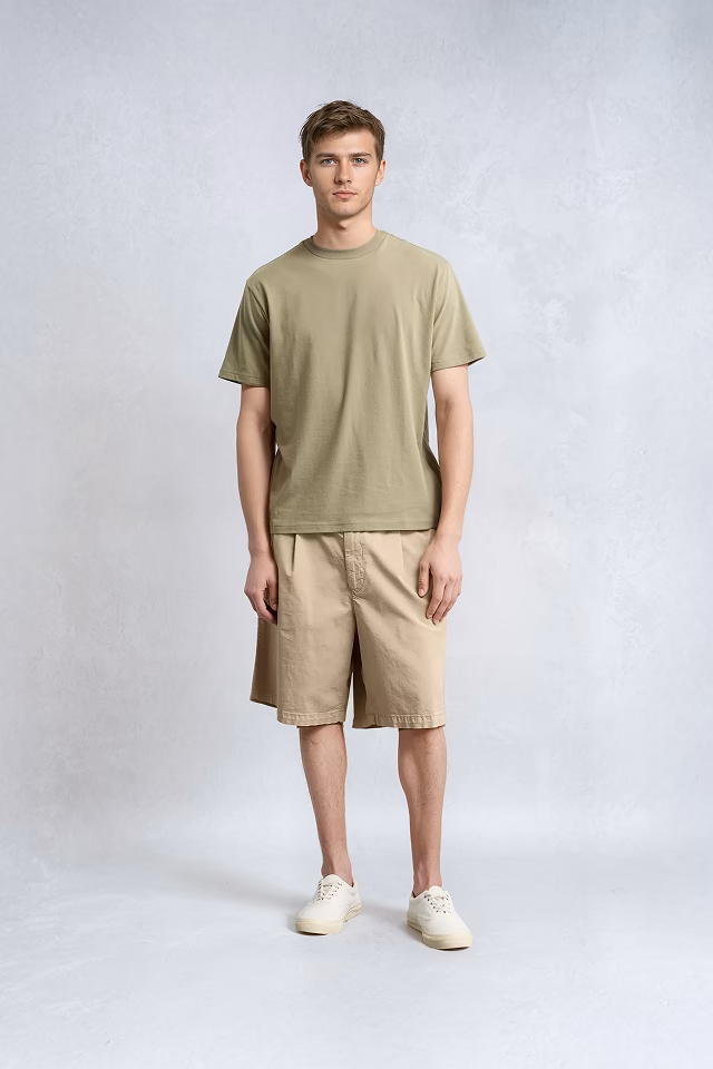 A Botika male AI fashion model, in green t-shirt and shorts