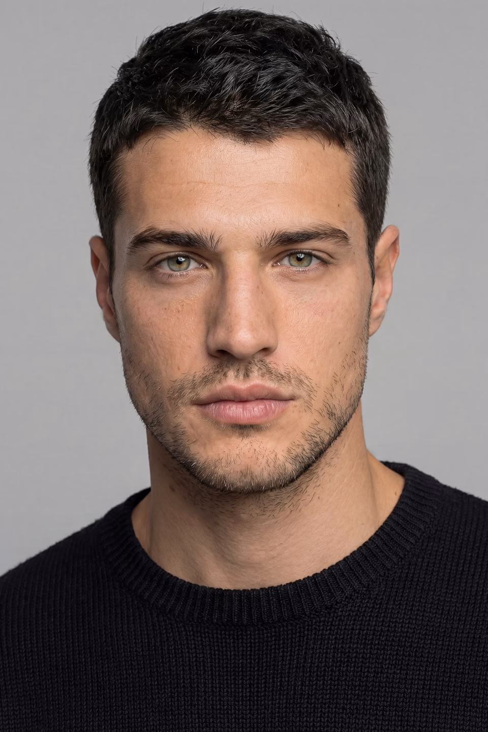 Nick, a male Botika AI fashion model's headshot wearing a black tshirt.