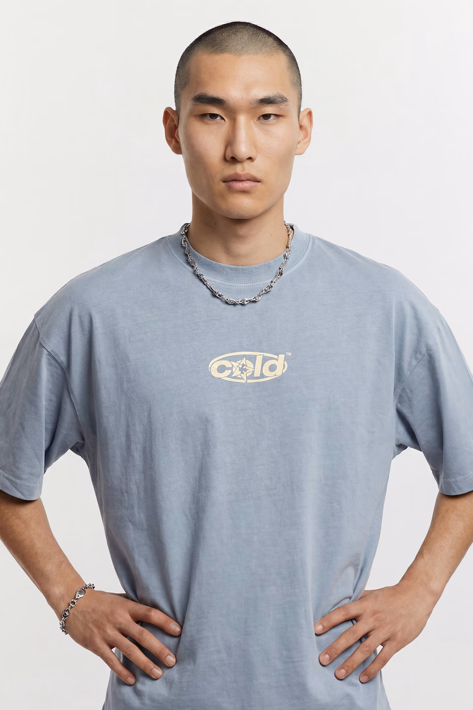 Kazuto a Botika Asian male AI fashion model wearing a powder blue surfer's tshirt.