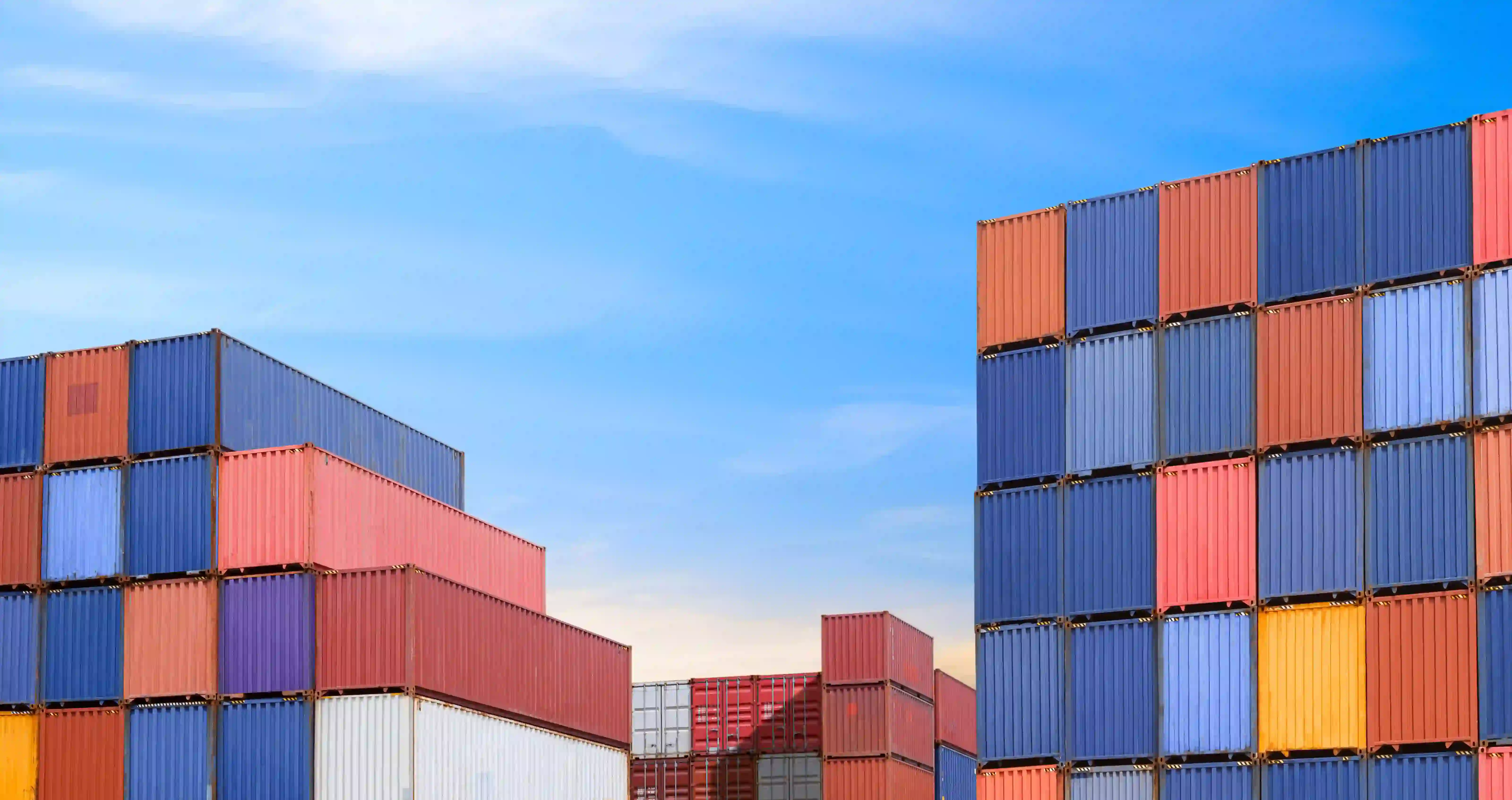 Image of colorful shipping containers stacked in rows. 