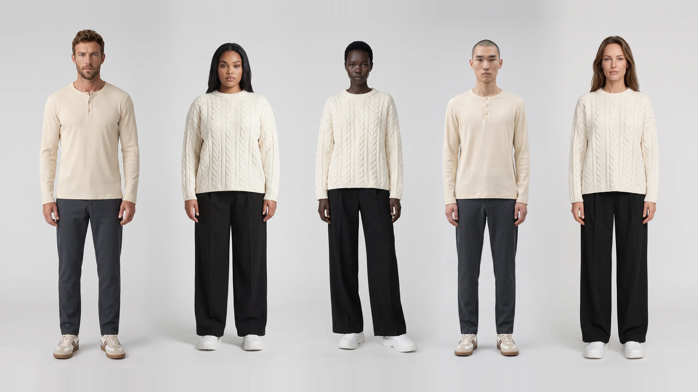 Five AI fashion models of different ages, body types and skin tones standing in a row against a light grey studio wall, each in a cream top and dark trousers