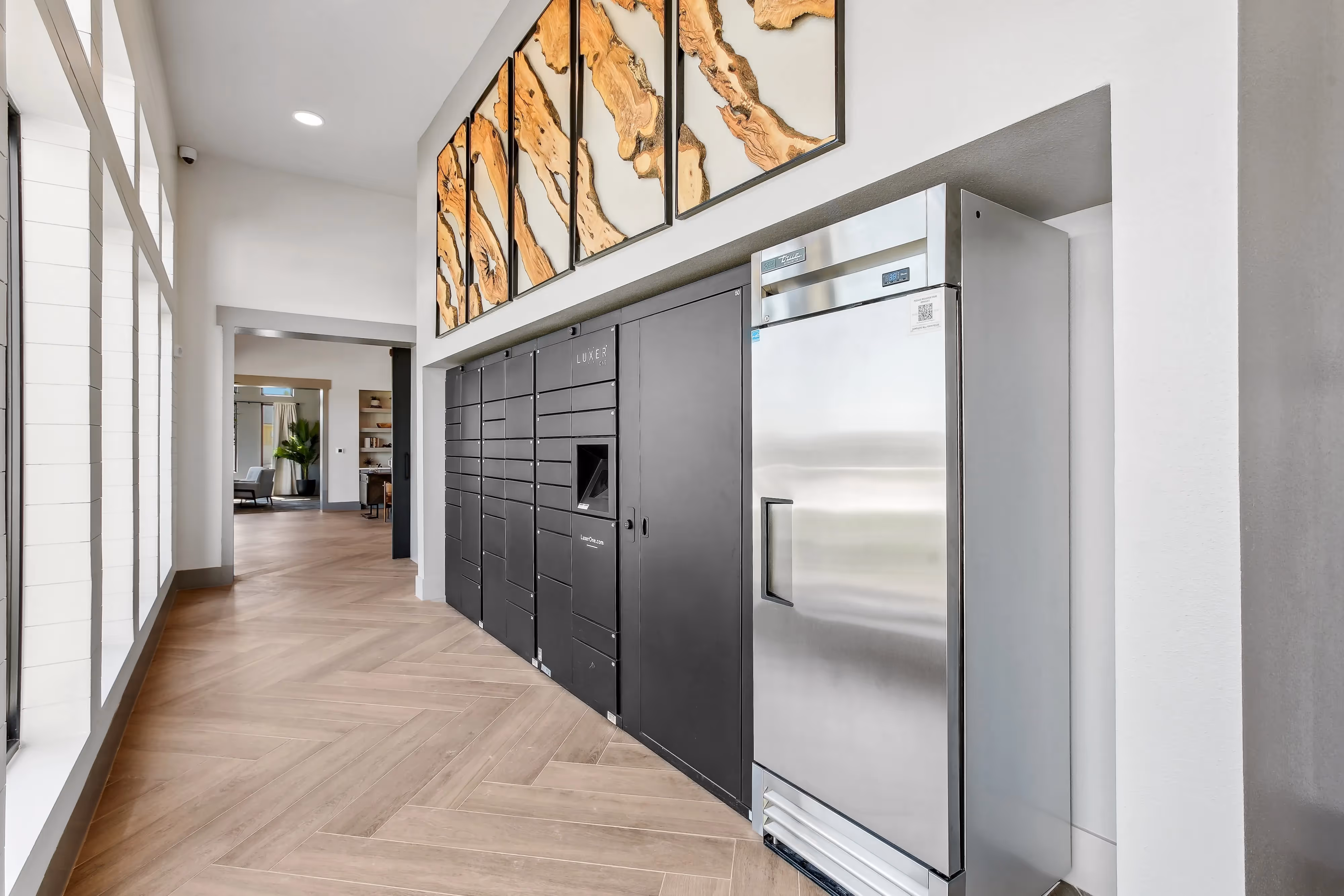 Secure package room and lockers for resident deliveries, with a modern design and decorative art, at Paloma Luxury Apartments in San Antonio, TX.