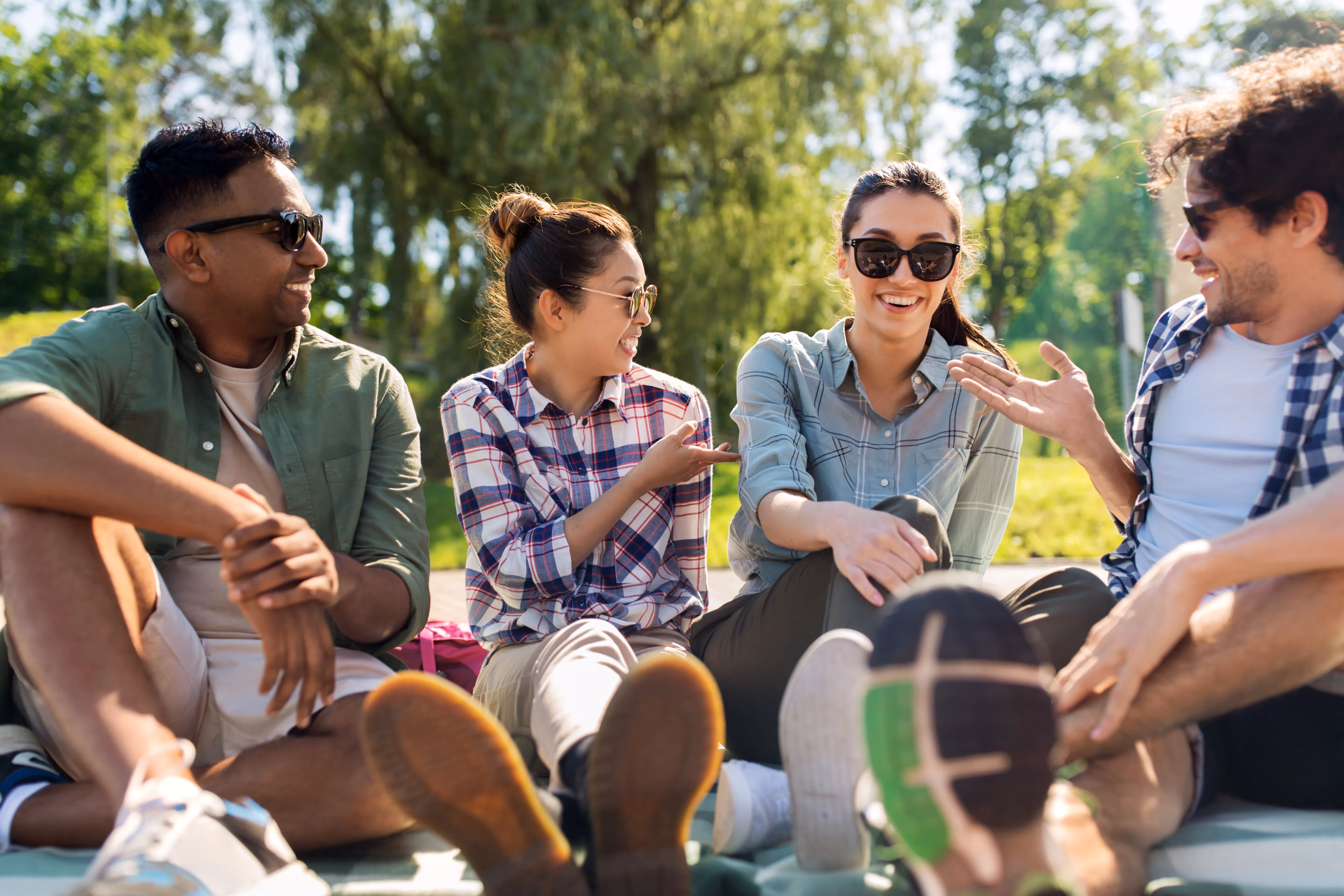 Group of friends smiling and laughing together outdoors, representing the vibrant social life near Paloma Luxury apartments in San Antonio, TX.