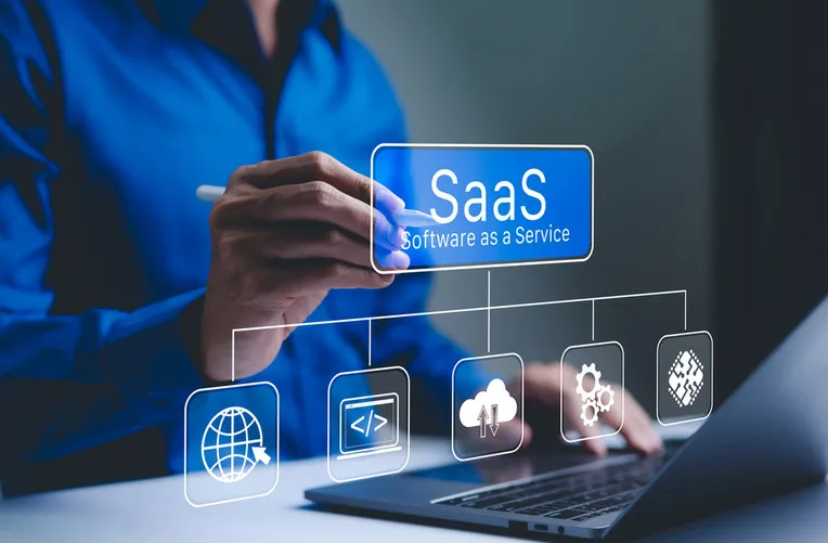 Person interacting with SaaS dashboard on laptop showing cloud, coding, and software service icons.