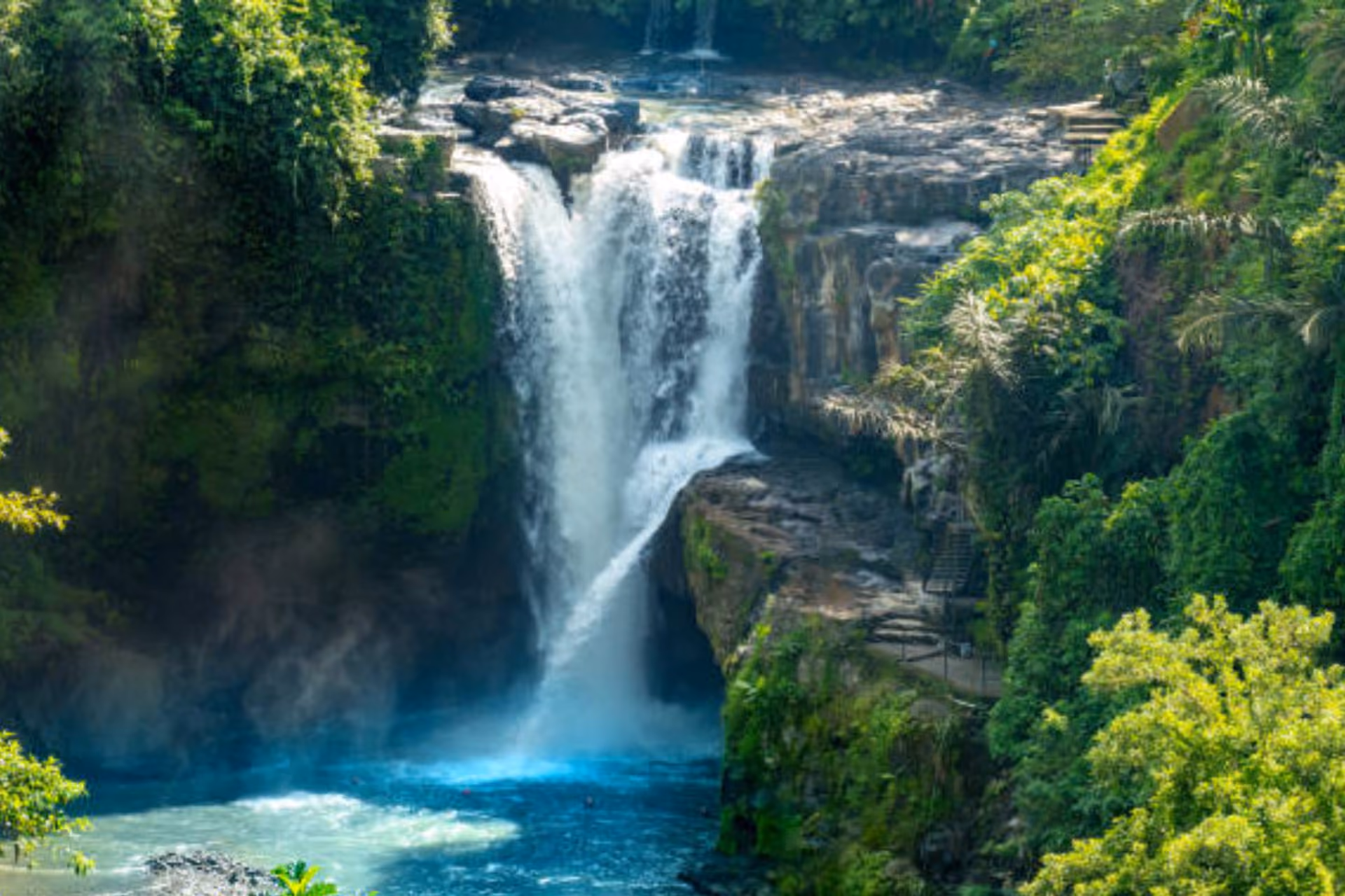 Water flowing over the cliff in Tegunangan Waterfall