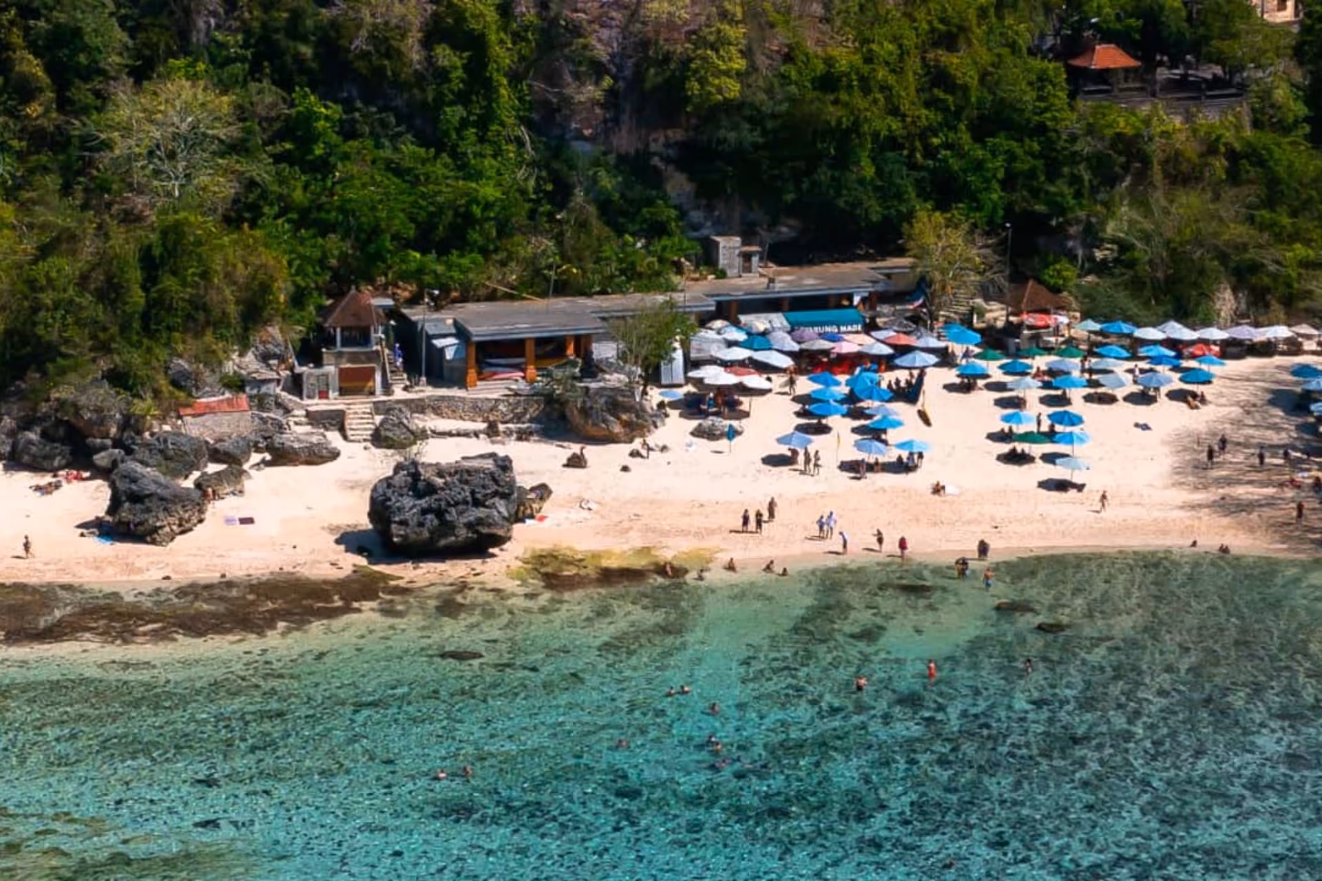People spending leisure time on Padang Padang Beach.