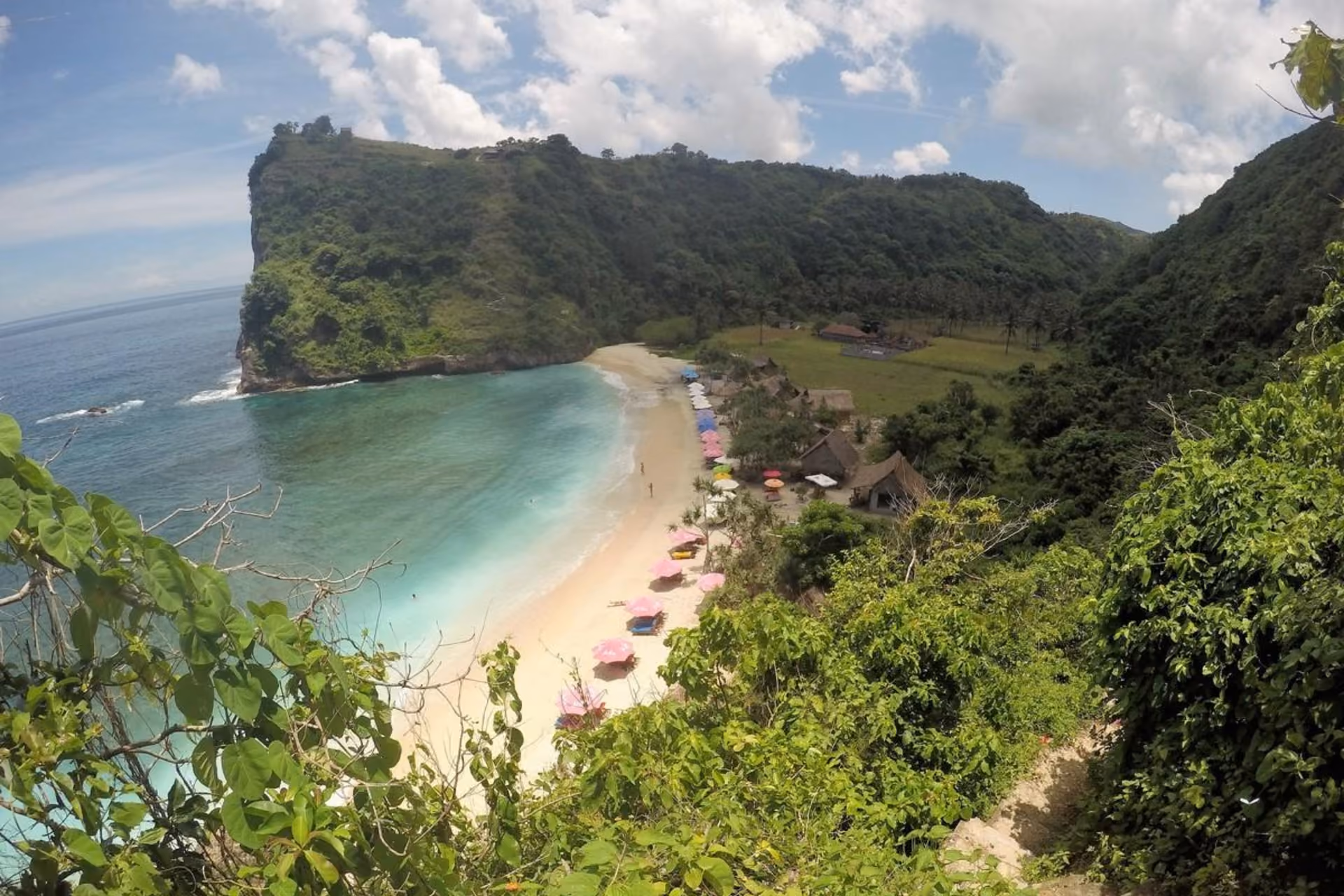 Atuh Beach, a tranquil spot surrounded by lush mountains.